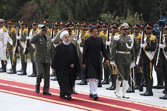 Pakistani Prime Minister Imran Khan (center right), reviews a guard of honor during his welcome by Iranian President Hassan Rouhani (center left) at Saadabad Palace in Tehran, Iran on April 22, 2019. (Photo: AP)