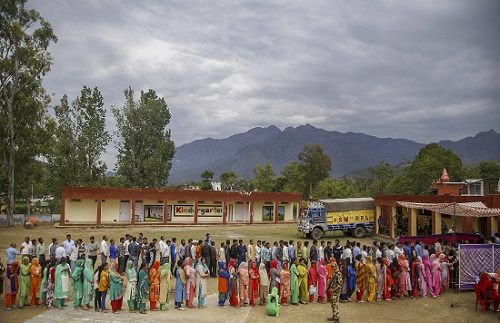 Voters standing in a queue to cast their votes during the second phase of General Elections at Tikri, Udhampur in Jammu and Kashmir on April 18, 2019. (Photo: PTI)