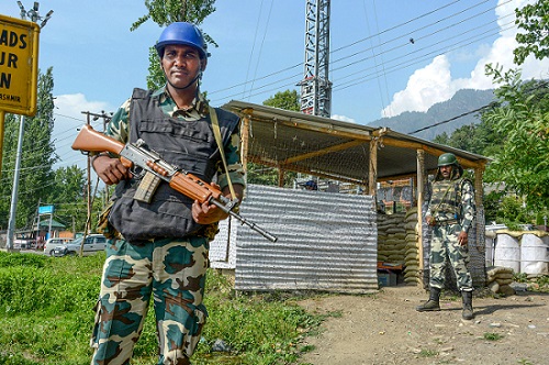 Security personnel guarding a newly constructed bunker on the banks of Dal Lake in Srinagar. Over the last few days tensions have mounted in Kashmir Valley over deployment of 10,000 security personnel fueling speculation that New Delhi might scrap Kashmir's special status. (Photo: PTI)