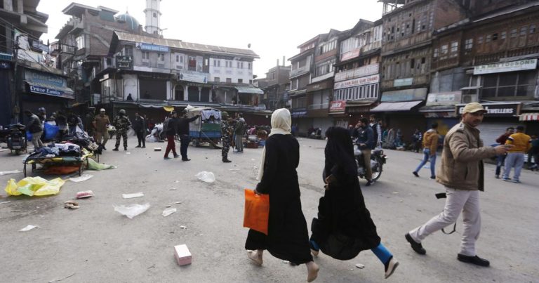 Local Kashmiris running away from the grenade blast site in Srinagar. (Photo: Reuters)