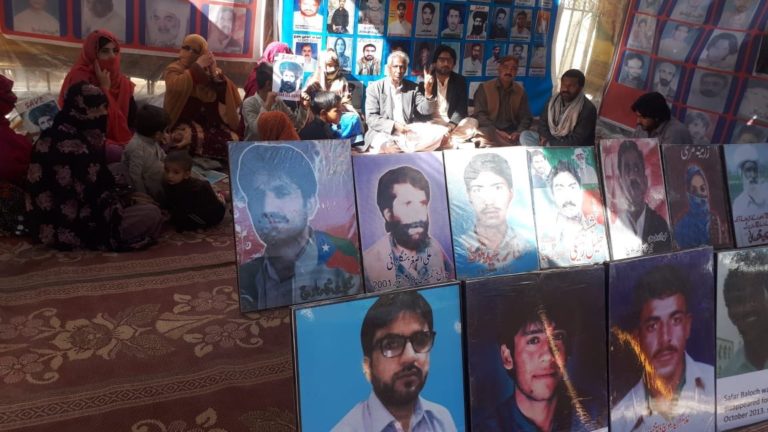 Baloch nationals protesting with photographs of 