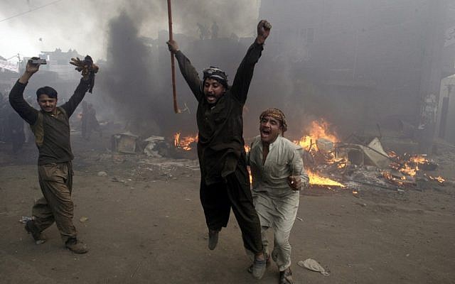 Pakistani men after burning the house of Christians in Lahore. (File photo: AP)