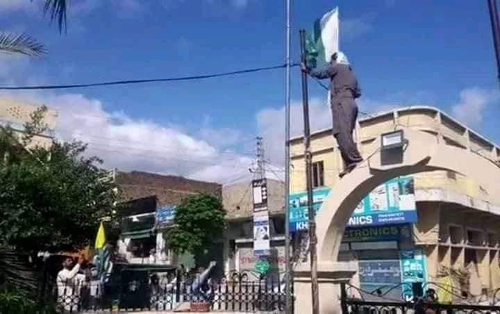 Tanveer Ahmed taking down Pakistan's flag at Maqbool Bhatt Square, Dadyaal POK (Pakistan-occupied Kashmir).