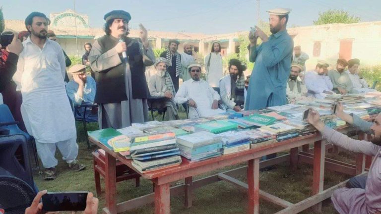 Ali Wazir (in black cap) during the inauguration of a public library at Waziristan in October 2020.