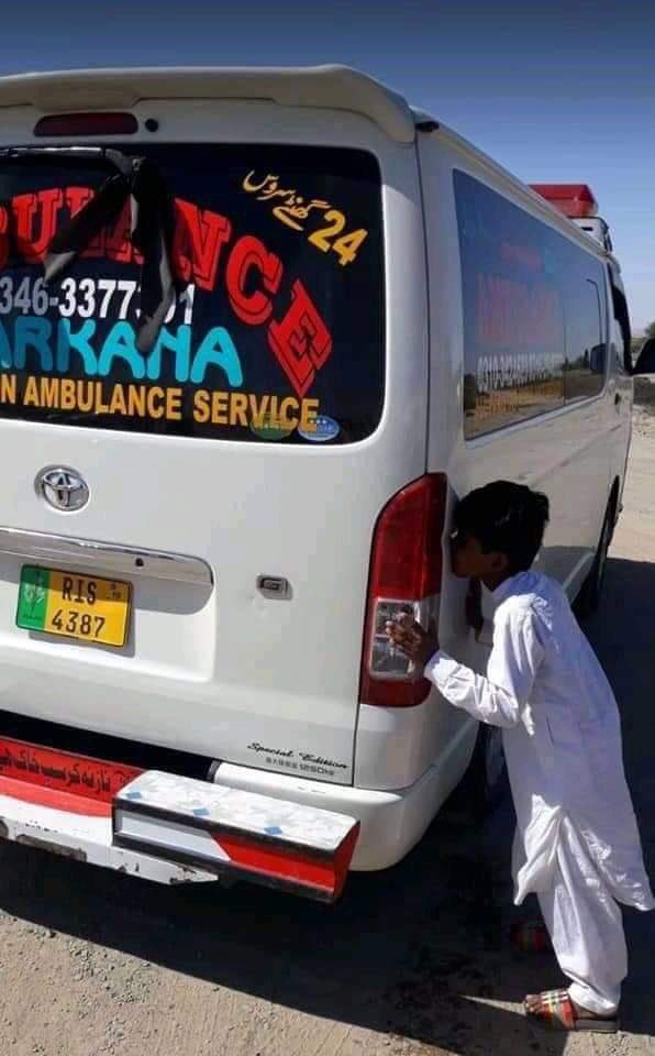 A Baloch boy kisses the ambulance carrying Karima Baloch's dead body. (Photo: News Intervention)