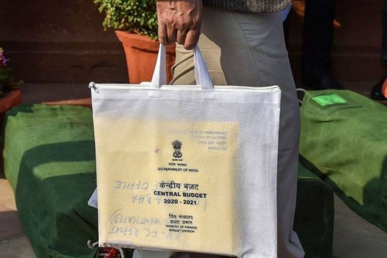 A Finance Ministry employee carries a copy of the Union Budget 2020-21 before its presentation in the Lok Sabha at New Delhi. (Photo: PTI)