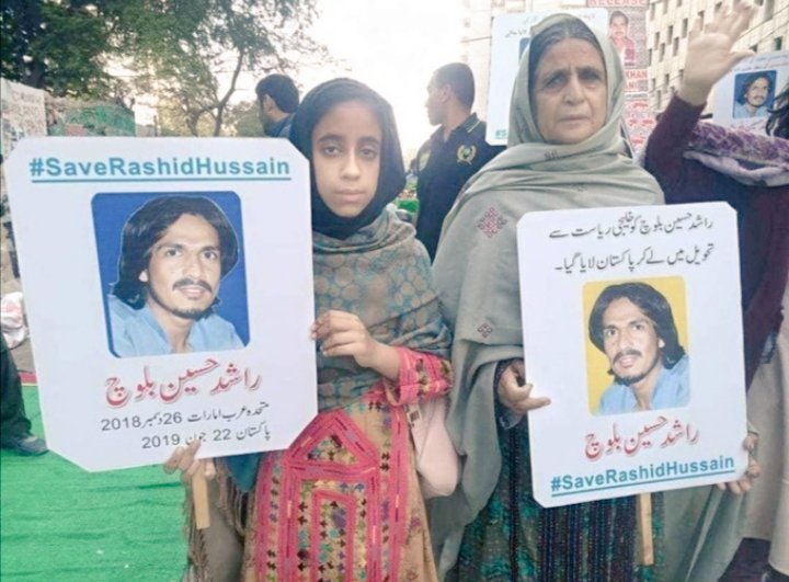 Rashid Hussain's mother and niece with placards asking Pakistani regime to release the Baloch human rights activist.