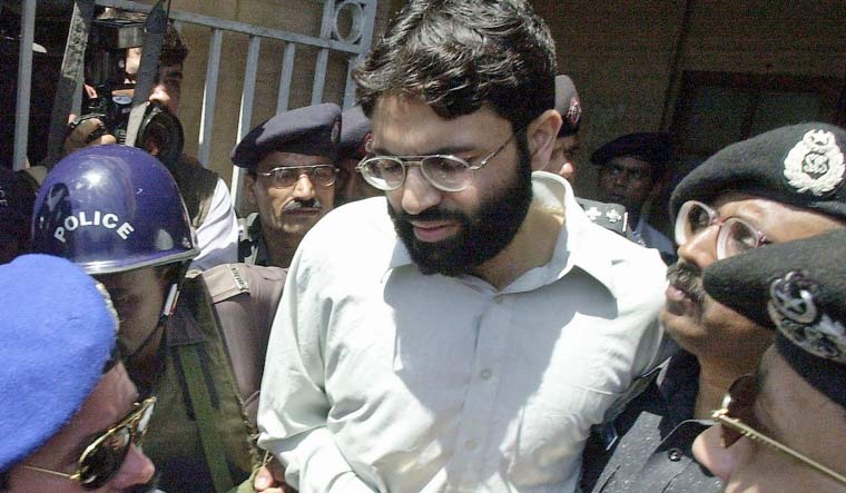 Policemen escorting Ahmed Omar Saeed Sheikh out of the court in Karachi. (File photo: AFP)