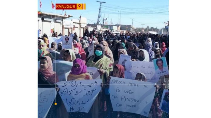 Men, women, and children gather to condemn human rights abuses in Balochistan.